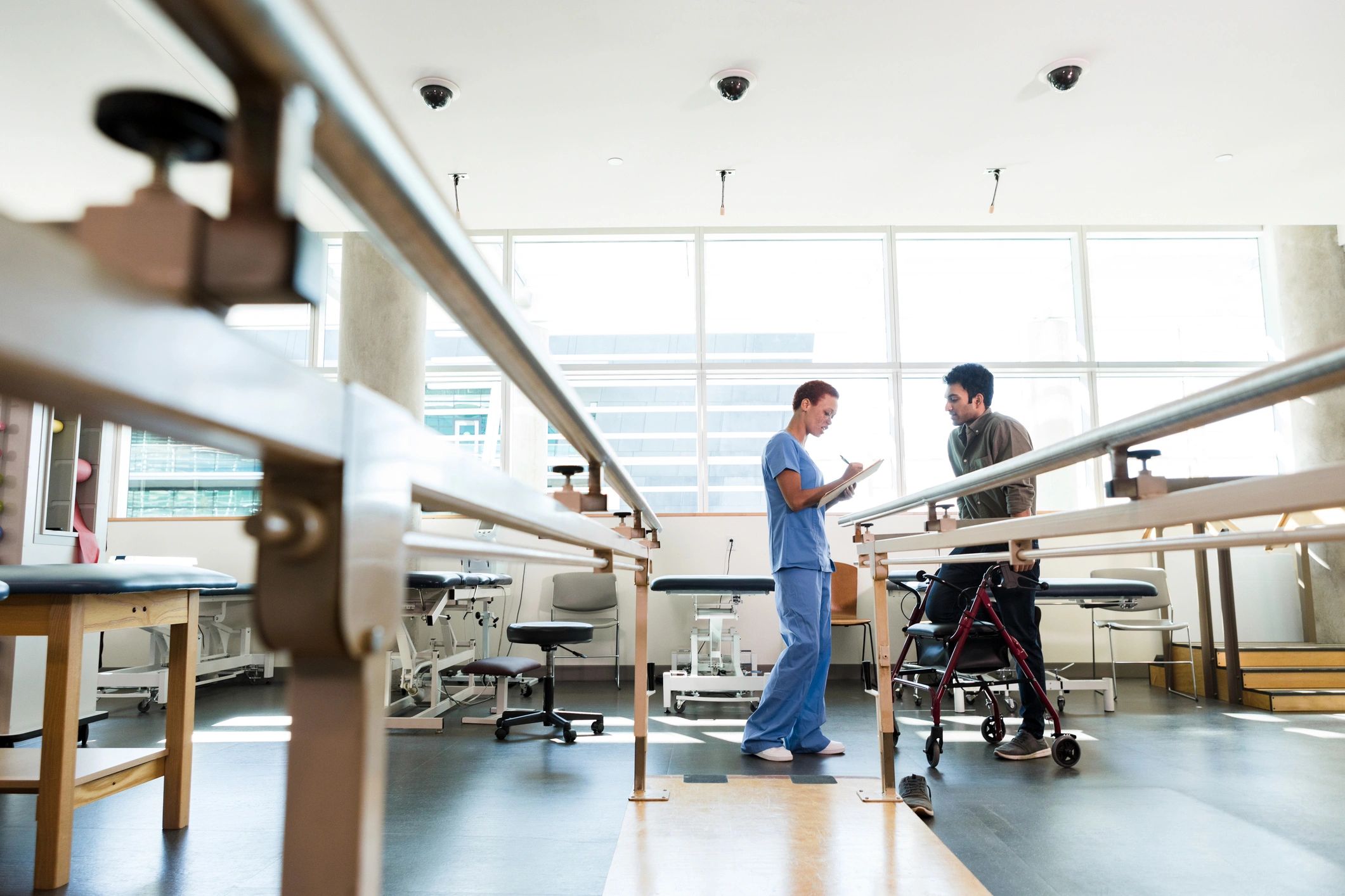 Physiotherapist supporting a patient during rehabilitation