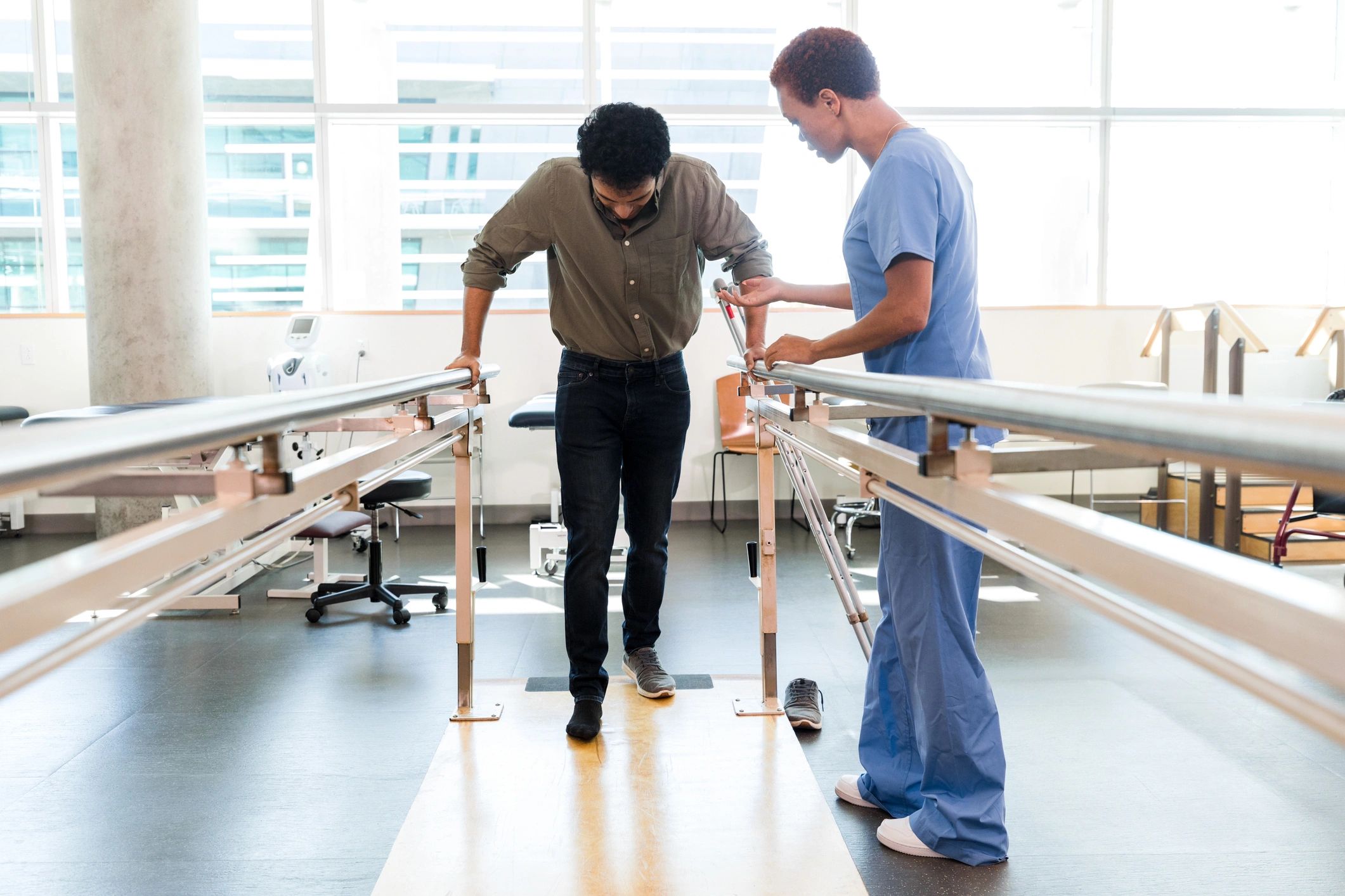 Physiotherapist guiding a patient through walking rehabilitation