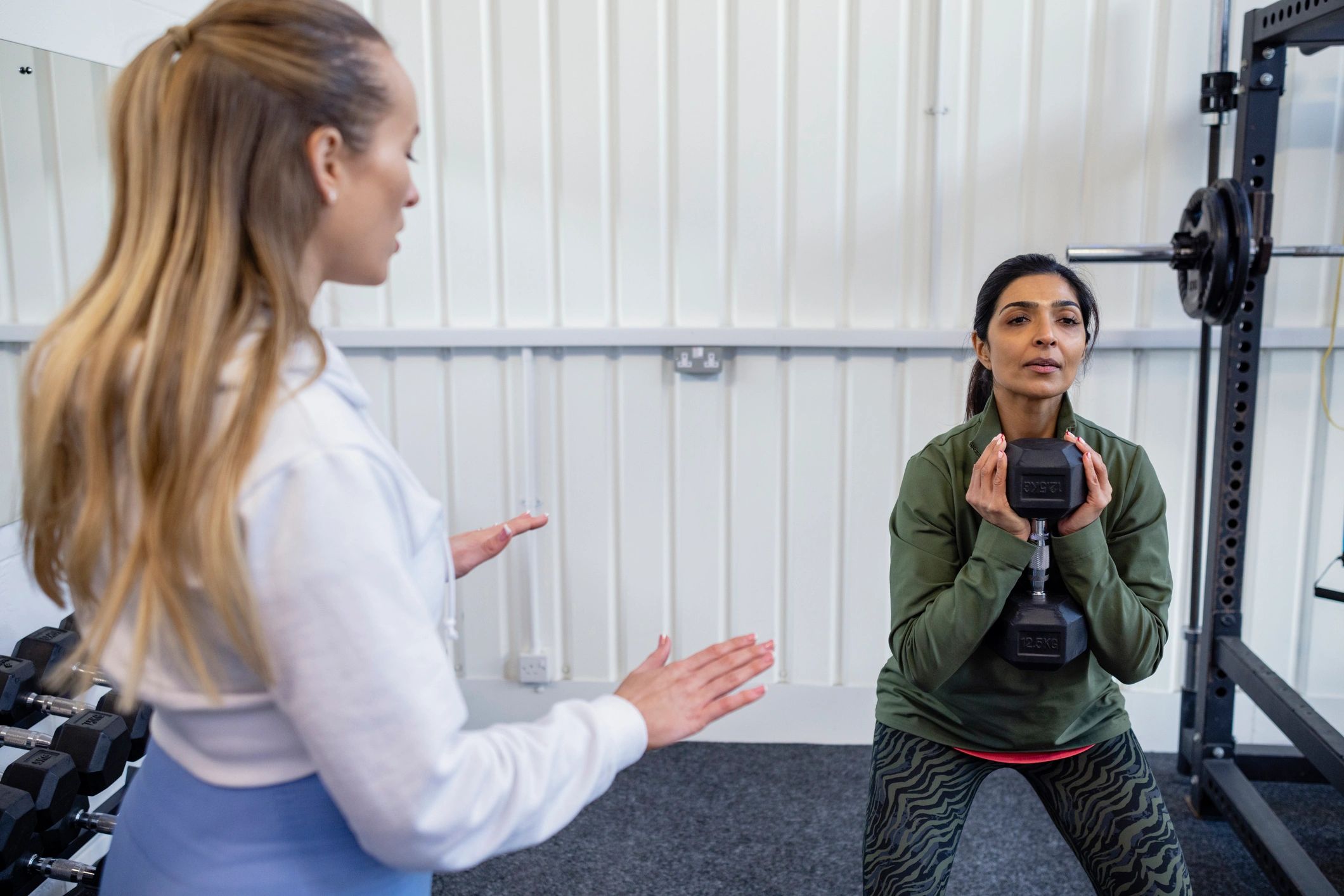 Therapist guiding a client through a strengthening exercise