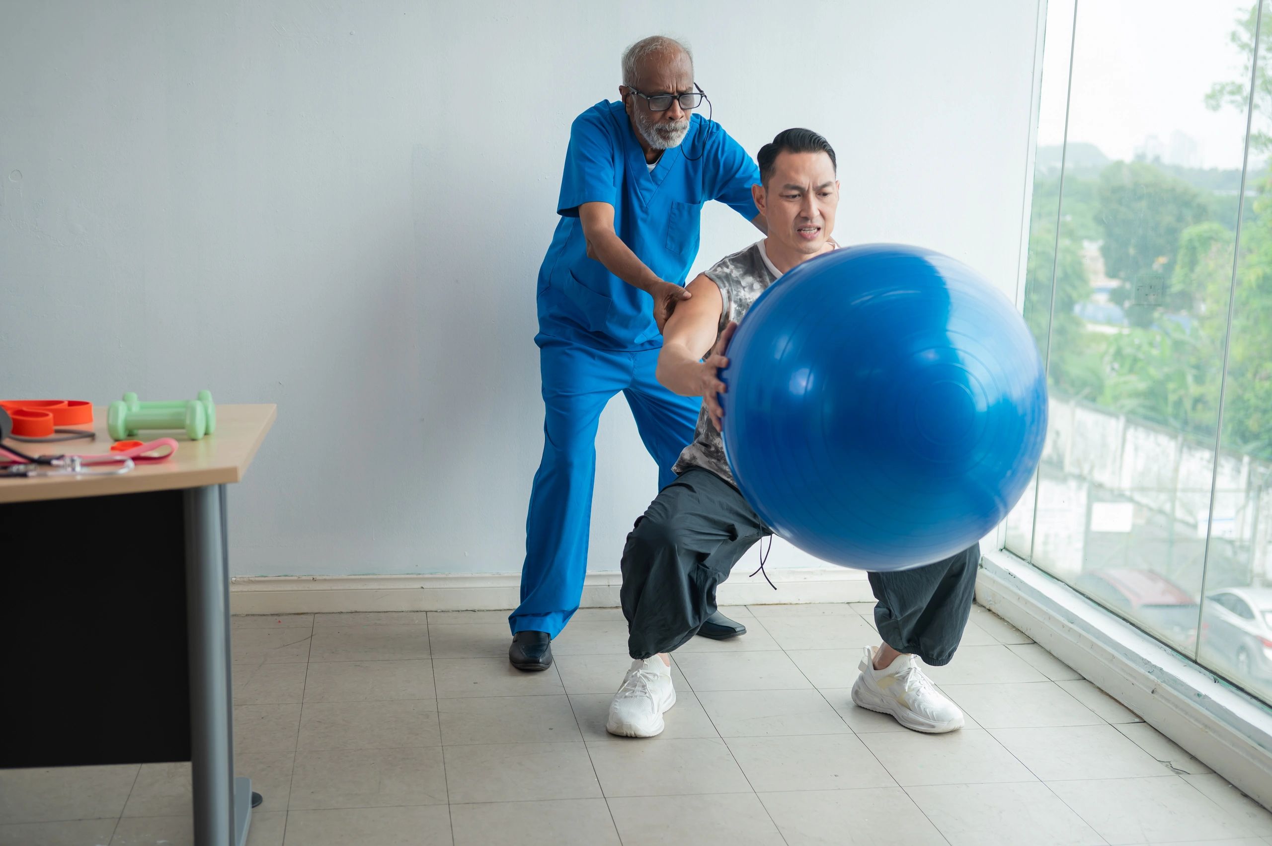 Patient exercising with a physiotherapist in a clinic